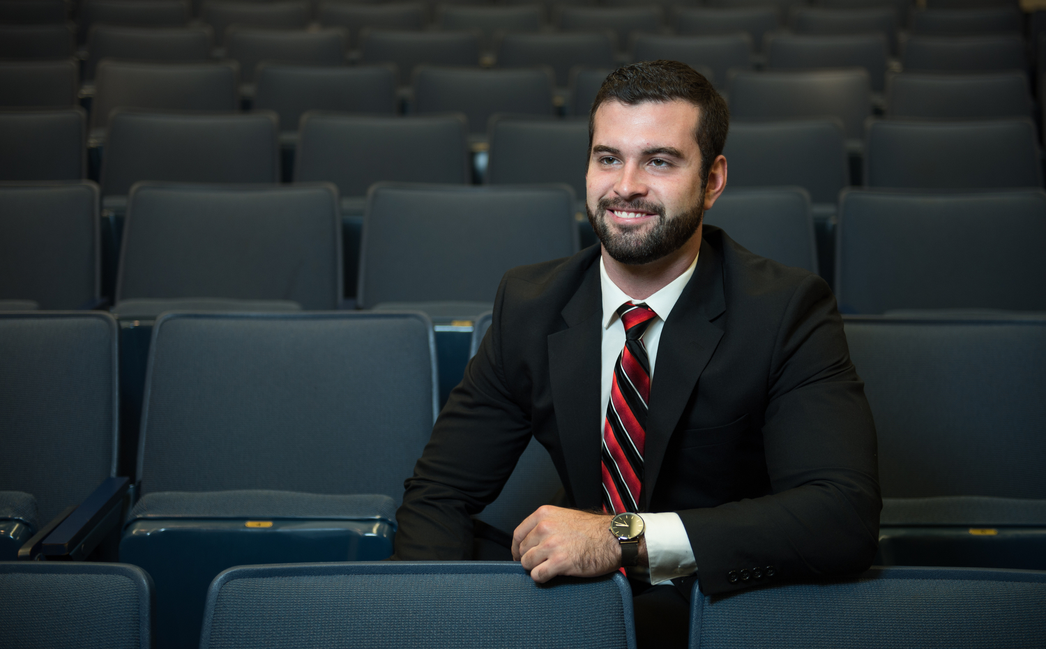 Carl L Gardner sits with empty chairs around him.